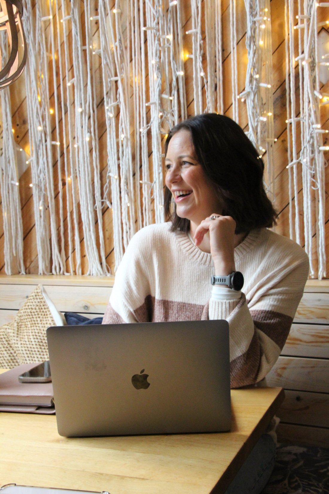 Sammy Kerrod smiling at her laptop